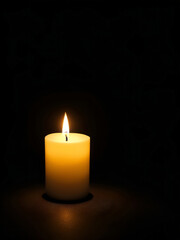 Obraz na płótnie Canvas a candle in the dark background