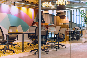 In the contemporary setting of an empty modern glass startup office, the space exudes a sleek and...