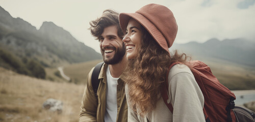 Happy couple smiling and laughing hiking in the mountains - obrazy, fototapety, plakaty