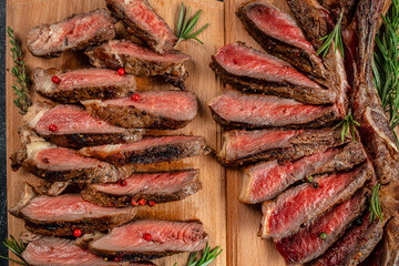 Sliced grilled beef barbecue Striploin steak on a wooden board, Restaurant menu, dieting, cookbook recipe top view