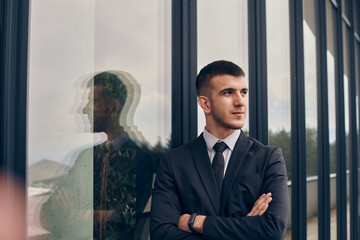 A CEO dressed in a sleek black suit stands confidently at the entrance of a modern corporate...