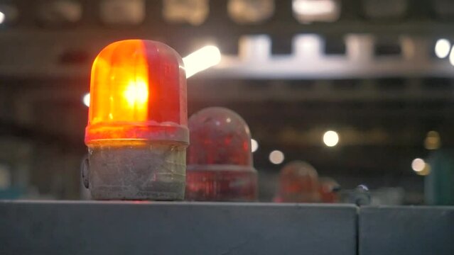 Red warning lamps at a factory. The warning lamp with flickering red light at a cardboard factory.