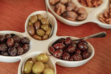 turkish breakfast table served, white dishes, wooden table, black and green olives, oily, fresh