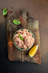 Bowl with canned Tuna on a wooden board. Food recipe background. Close up © Надія Коваль