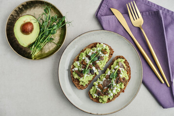 Avocado toast  with mushrooms, feta cheese and microgreens