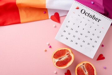 Top-down shot of Lesbian Pride flag with delicate hearts expressing emotions, October calendar, and...