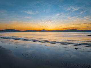 Pretty sunrise at the seaside with high cloud and low tide