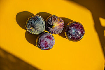 Black fig fruit with yellow background