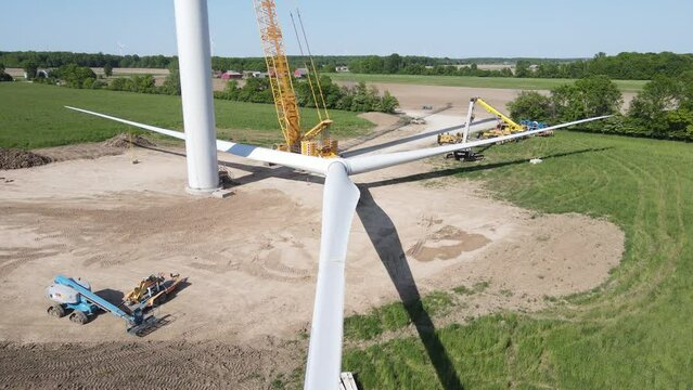 Wind turbine blades ready to be lifted on top, aerial ascend view