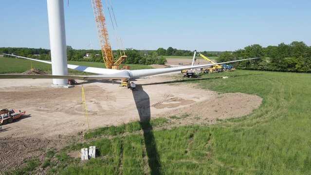 Construction process of wind turbine in Michigan, USA, aerial orbit view