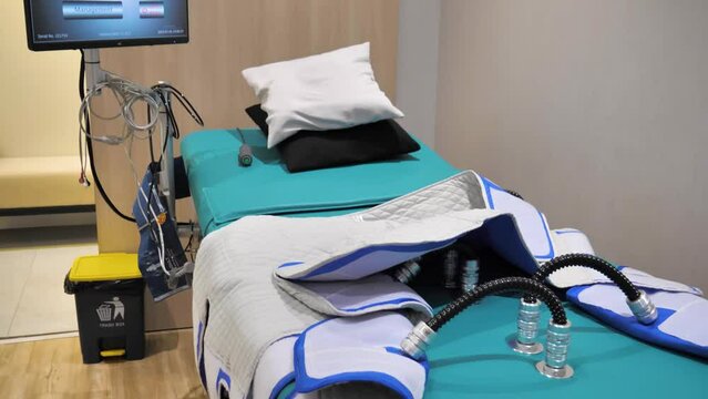 Slow motion establishing shot of EECO physical therapy equipment lying on the bed