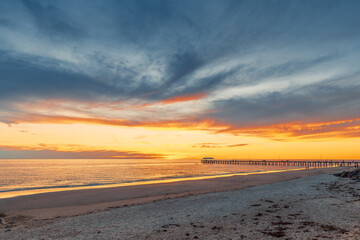 Fototapeta na wymiar Henley Beach coastline with jetty at sunset, South Australia