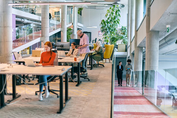 In a modern startup office, a diverse group of young professionals collaboratively tackles various business problems and challenges, surrounded by their engaged colleagues, fostering innovation and