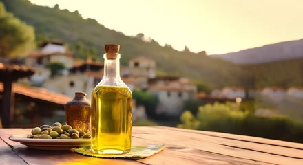 Zelfklevend Fotobehang A bottle of olive oil on a wooden table against the backdrop of a Mediterranean village in sunset light. Mockup, copy space © Marina