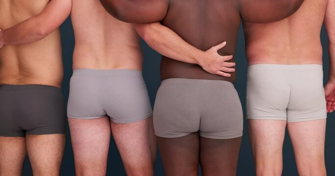 Body positivity, diversity and men in underwear with community, confidence and back of plus size people in studio. Friends, group and male beauty on grey background with solidarity and pride together