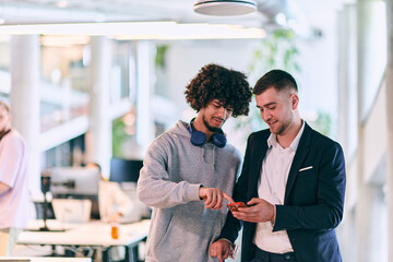 In a modern office setting, an African American businessman engages in a discussion with his director, using a tablet to address business challenges, symbolizing collaboration and technology