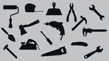 A set of silhouettes of construction tools. 16 pieces. Vector on a gray background.
