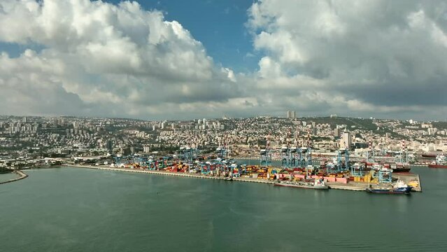 Haifa commercial port dock with Container ship, stacked shipping containers and cranes