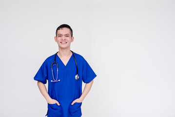 Portrait of a young and skilled medical student, nurse, intern posing with both hands inside pockets. Isolated on a white background.
