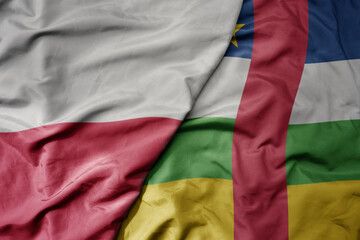 big waving national colorful flag of poland and national flag of central african republic .