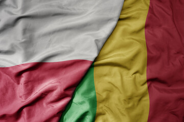 big waving national colorful flag of poland and national flag of mali .