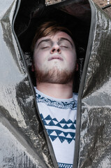 The body of a young man inside a body bag about to be zipped up.