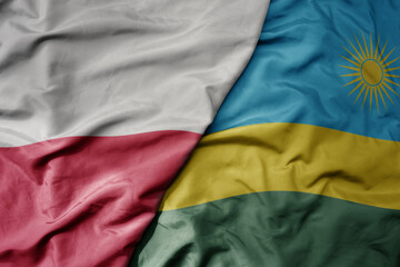 big waving national colorful flag of poland and national flag of rwanda .