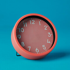 pink clock without hands on a blue background