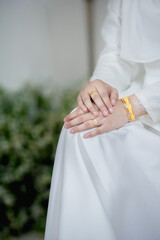close up hand muslim bride in white dress catch the wedding ring.concept for wedding card background, poster,Invitation card