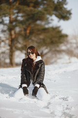 Outdoor photo of fashionable female in winter park
