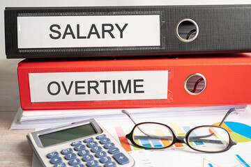 Salary, Overtime. Binder data finance report business with graph analysis in office.
