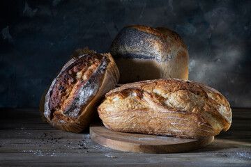 Freshly baked bread on a round wooden cutting board