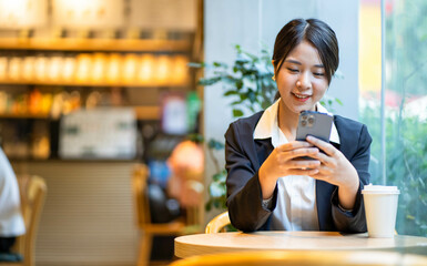 Asian businesswoman sitting and working at a cafe