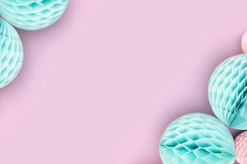 Frame made of tissue paper balls on a purple background. Composition with copy space.