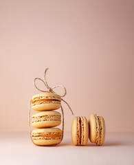 Macaroons on a beige background rope