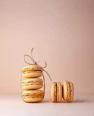 Selbstklebende Fototapete Macarons Macaroons on a beige background rope
