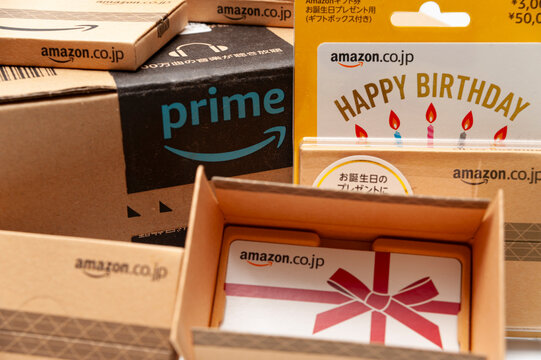 Fuji, Shizuoka, Japan - August 11, 2022: Cardboard box with Amazon Prime logo and various Amazon gift card box type sold in Japan isolated on white background