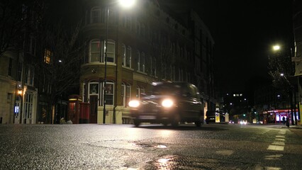 Fototapeta na wymiar Cars Driving London Streets at Night