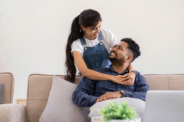 couple living together cuddling in the living room happy expression of love.