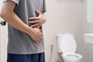 Constipation and diarrhea in bathroom. Hurt man touch belly  stomach ache painful. colon...