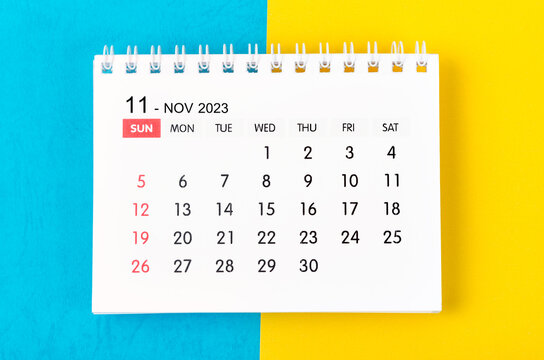 The November 2023 Monthly desk calendar for 2023 year on blue and yellow background.