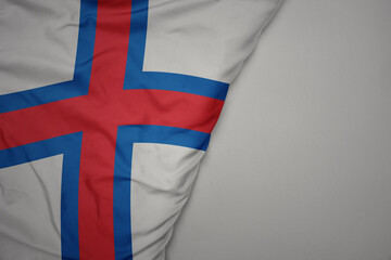 Fototapeta premium big waving national colorful flag of faroe islands on the gray background.