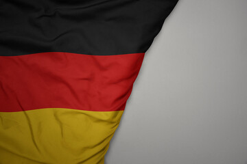 big waving national colorful flag of germany on the gray background.