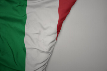 big waving national colorful flag of italy on the gray background.