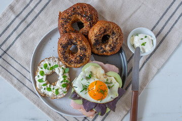 home made whole grain Bagels with cheese on a table