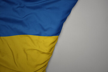 big waving national colorful flag of ukraine on the gray background.