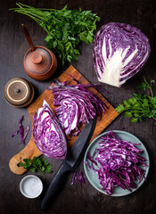 Chopped red cabbage close-up on a cutting wooden board in the kitchen