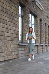 woman walking around the city with coffee in her hands