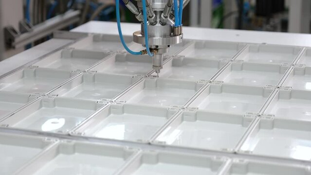 Liquid gasket dispensing machine. Liquid gasket close up.