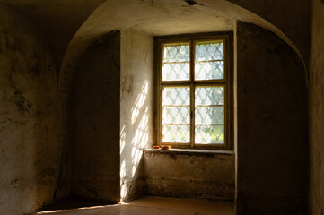 Abandoned baroque style room with window and wooden floor